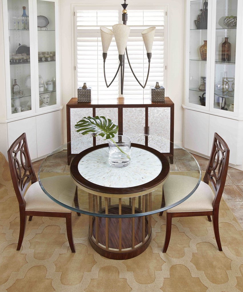 Figure 1FFDM's Boulevard Collection: The warmth of food is balanced by the water element and green leaf in a glass vase. The white cabinets house the most beautiful collections. As for accessories, what could be more interesting than the distinctive modern chandelier and silver cubed candelabra?