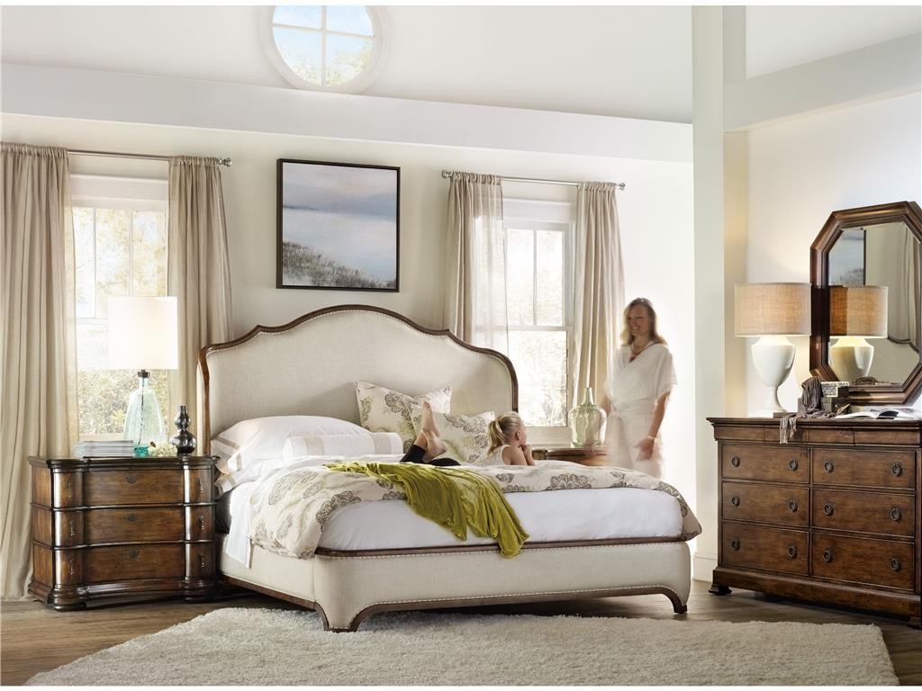 The Archivist Collection by Hooker Furniture features an open-air bedroom with curtains drawn and windows opened to let in sunlight and fresh air.