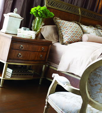 FFDM's Sunset Canyon Collection features this bedroom with a beautiful fusion of wood, gold and silver. The vase greens played well with the prints on the pillows and the armchair.