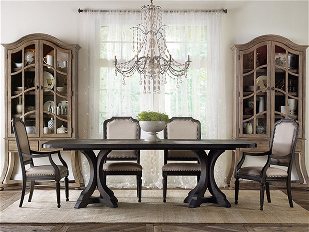 Hooker Furniture Corsica Collection: This is the perfect harmony of contradicting elements – from dark and light, curvy and straight, distressed and block colors. The unique vase of greens in the middle of the table provides a fresh divergence.