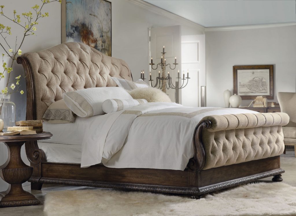 The Hooker Furniture Bedroom Rhapsody King Tufted Bed is nested in a neutral background. Its wooden frame pops from this sea of neutrals.